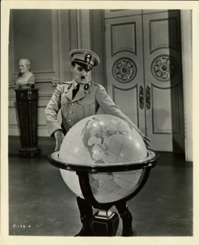 Chaplin as Hynkel beside a globe in The Great Dictator