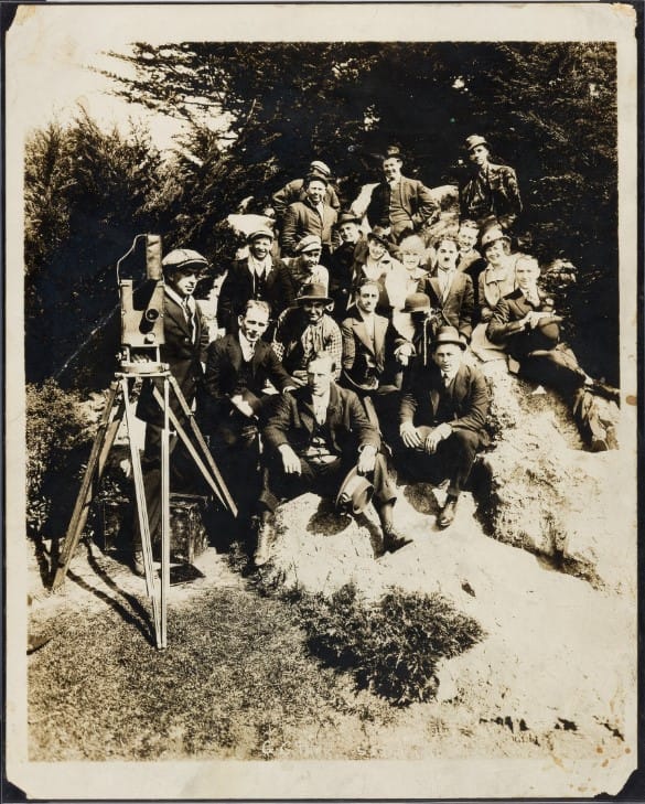 Charlie Chaplin and the Essanay film crew gathered beside a camera in Golden Gate Park