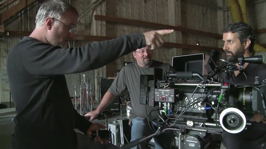 David Fincher directing beside the camera crew on The Social Network set