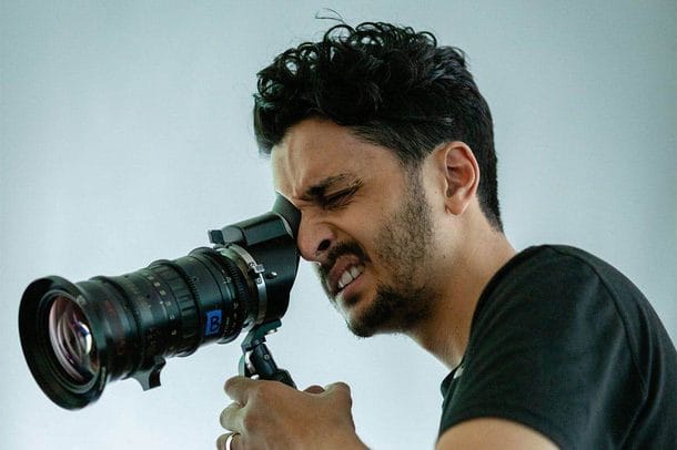 Imran Perretta looks through a camera viewfinder while filming the destructors