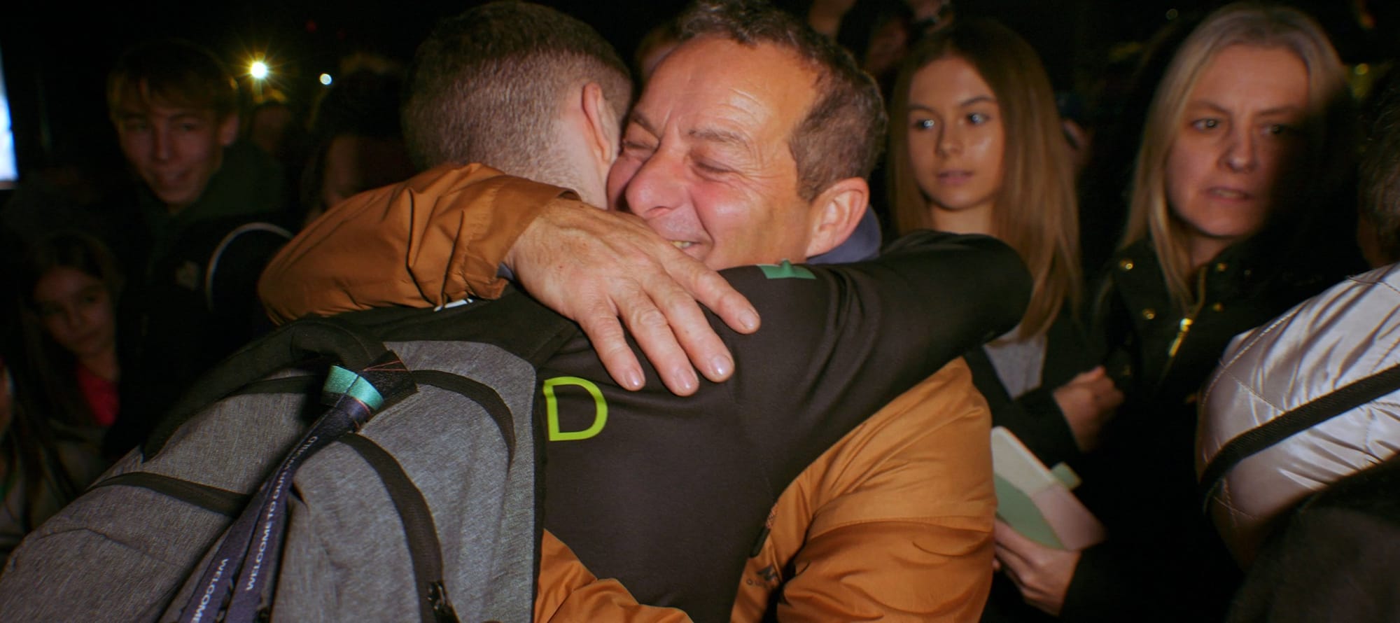 An embrace in a scene from Chasing Gold